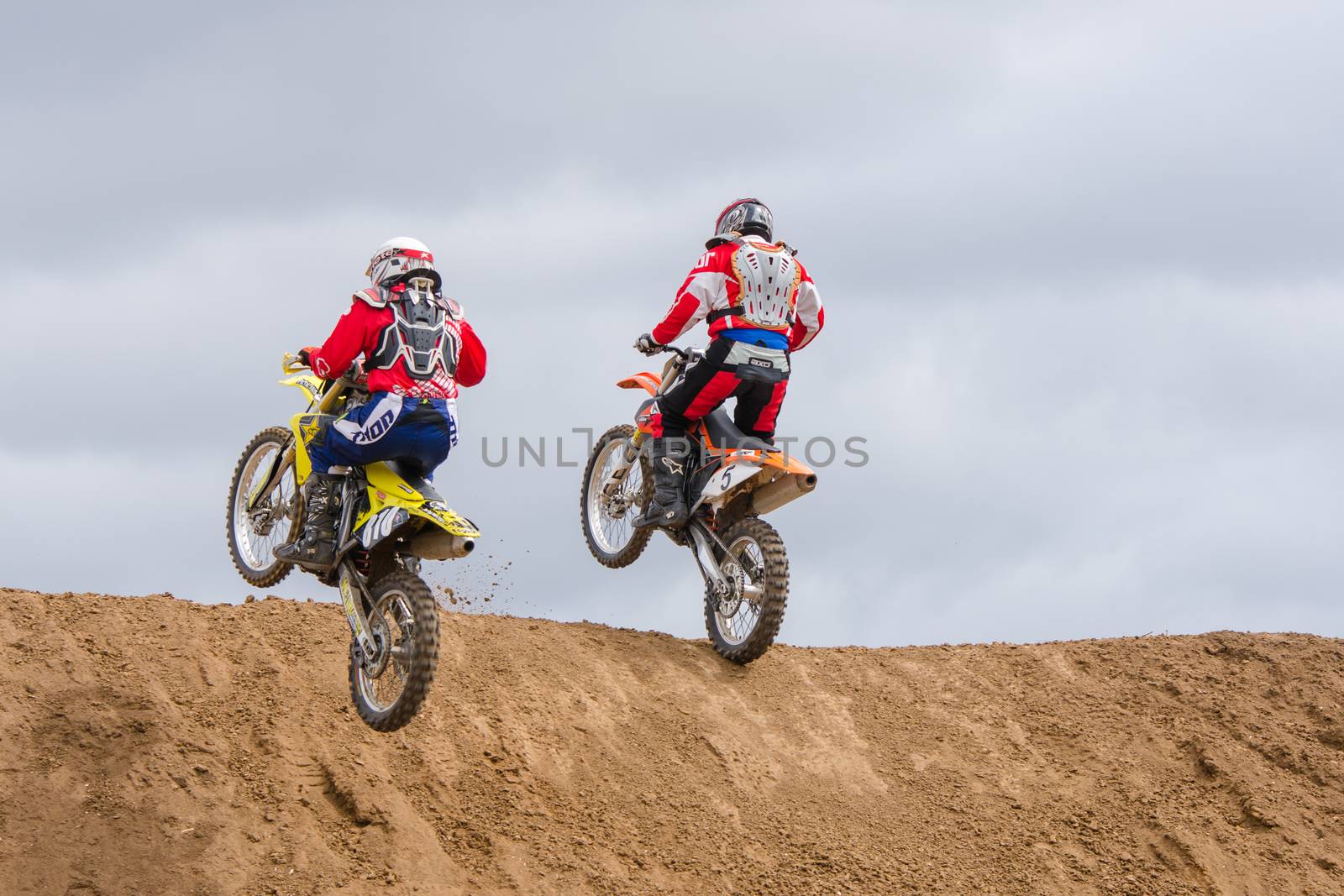 Volgograd, Russia - April 19, 2015: Two motorcycle racer climb onto the next obstacle on the stage of the Open Championship Motorcycle Cross Country Cup Volgograd Region Governor