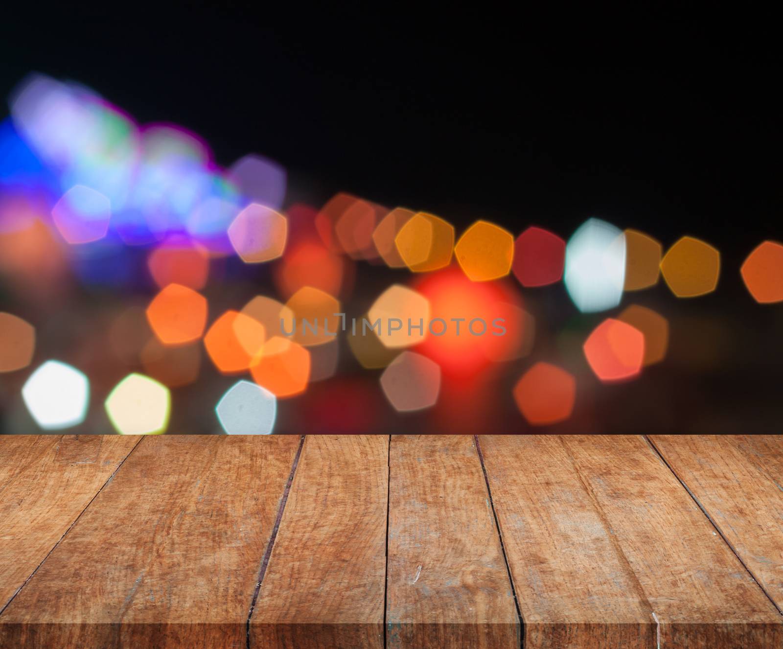 Top wooden with abstract blurred night lights by punsayaporn