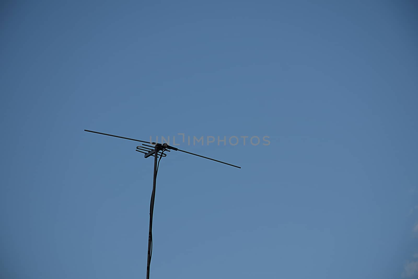 televisions antennas with clear sky background.