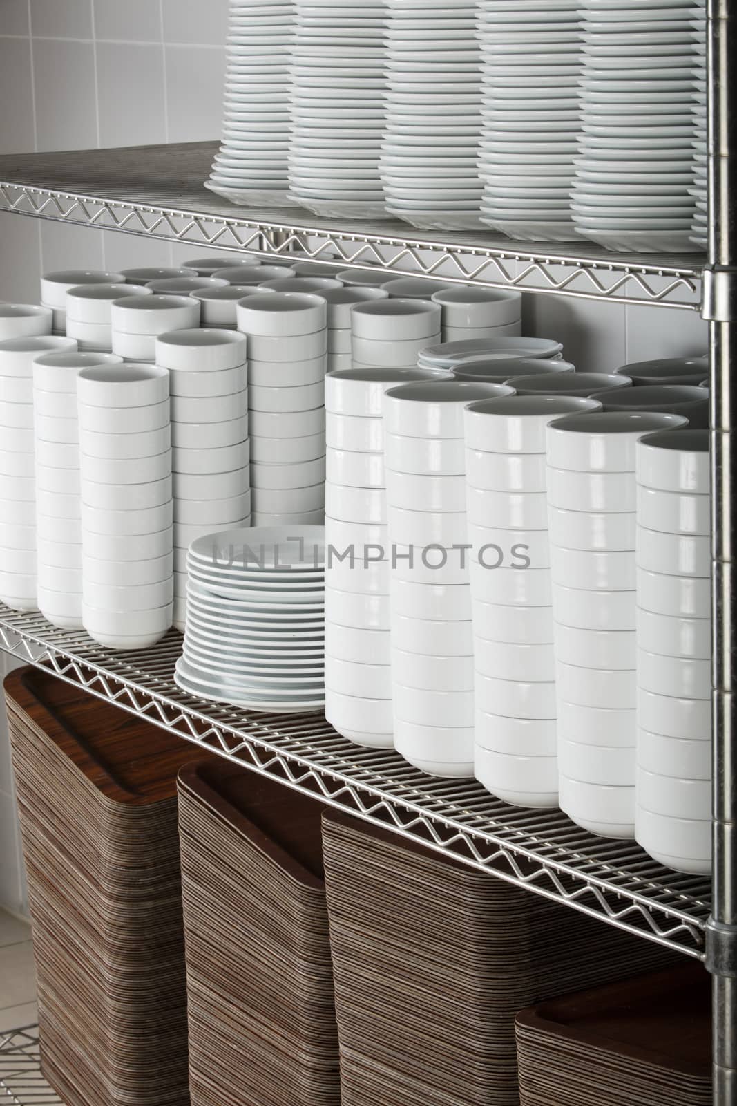 many white plates on a wire rack by senkaya