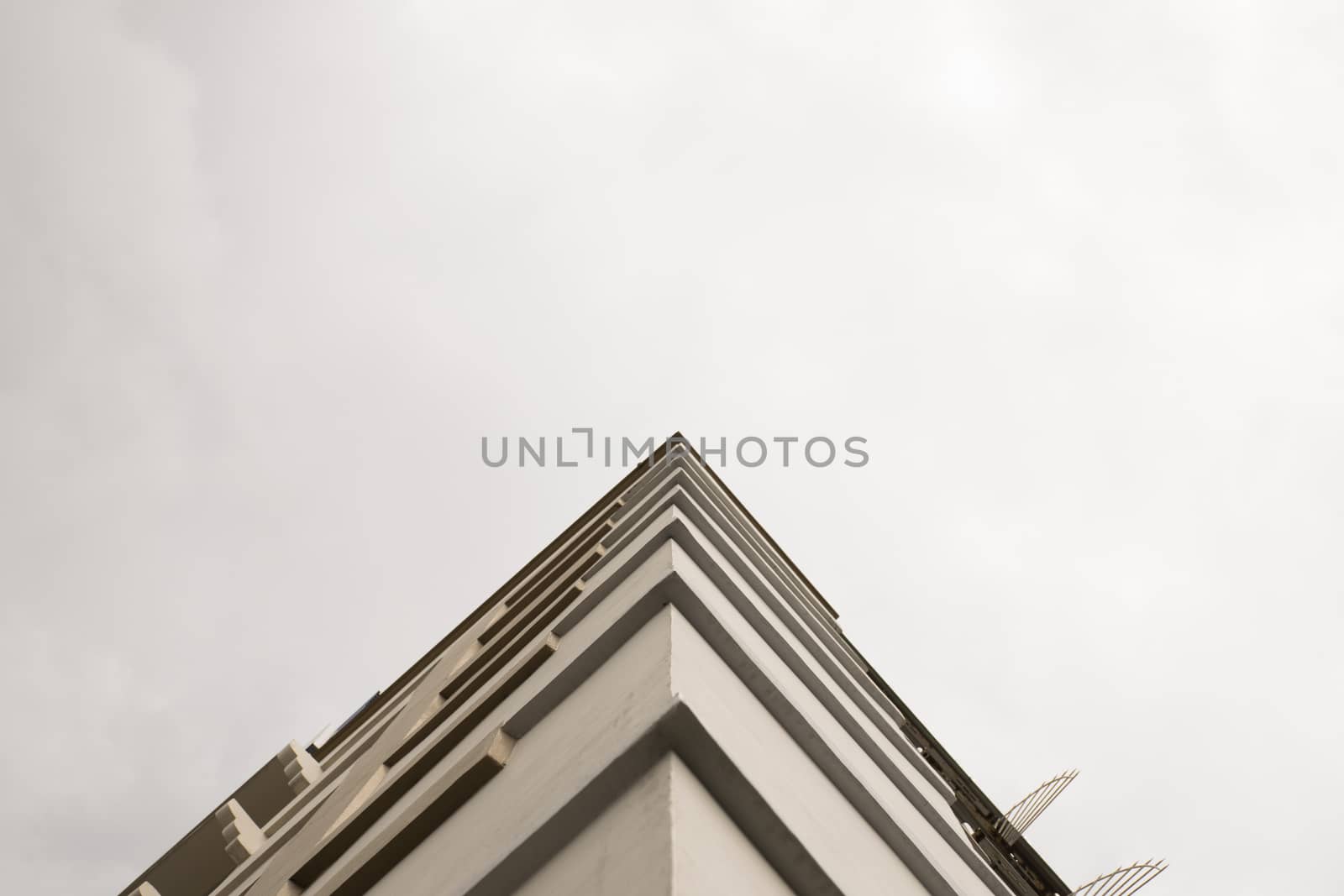 Look up at apartment housing in Thailand. Step of building.