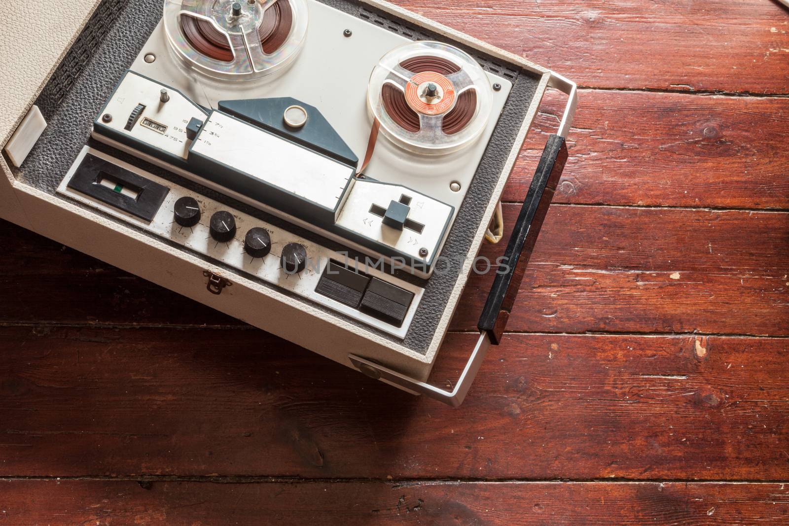 Old tape recorder on wooden background by andongob