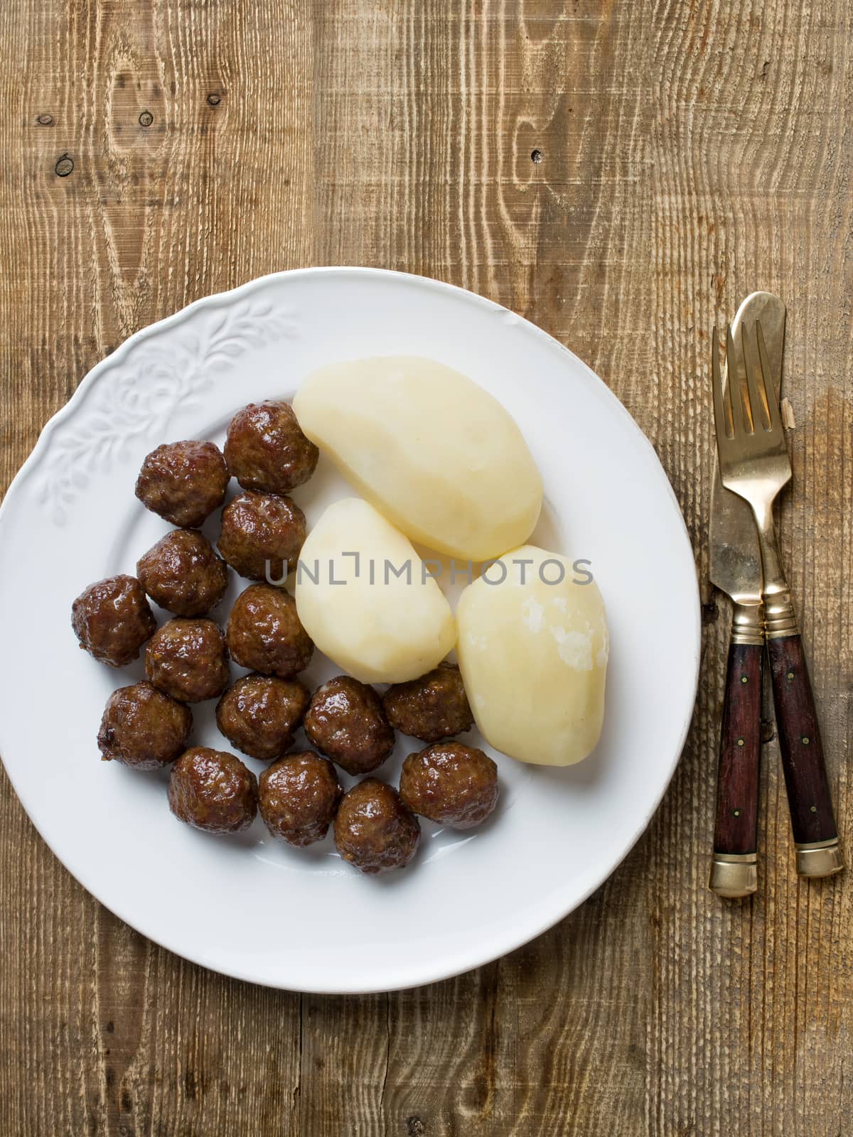 close up of rustic swedish meatball and potato