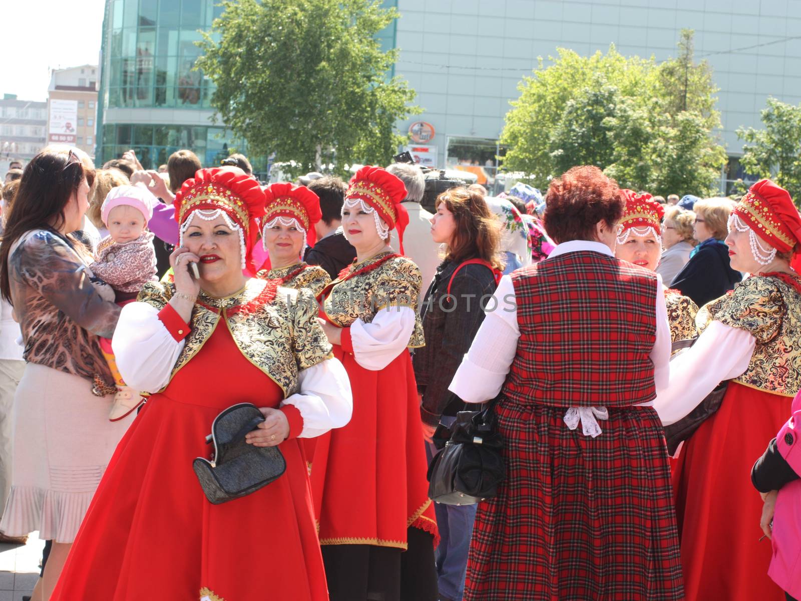 Woman in national dress calling on a cell phone by AndrewBu