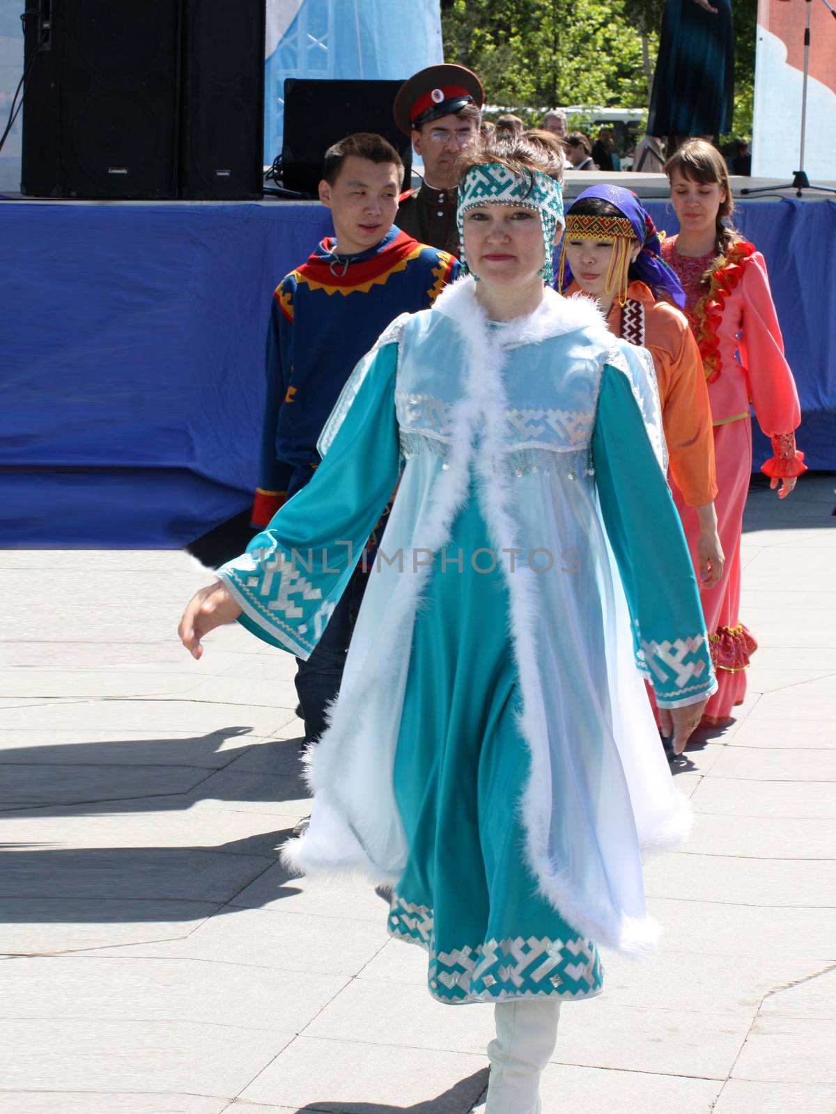 Tyumen, Russia - May 26 2012. Festival of national cultures Friendship Bridge. Peoples in Kazakh national dress ready for a concert. In the backyard are the presentation of the national dishes, show rituals are examples of arts and crafts, conduct master classes of traditional national crafts and trades and local cuisine.