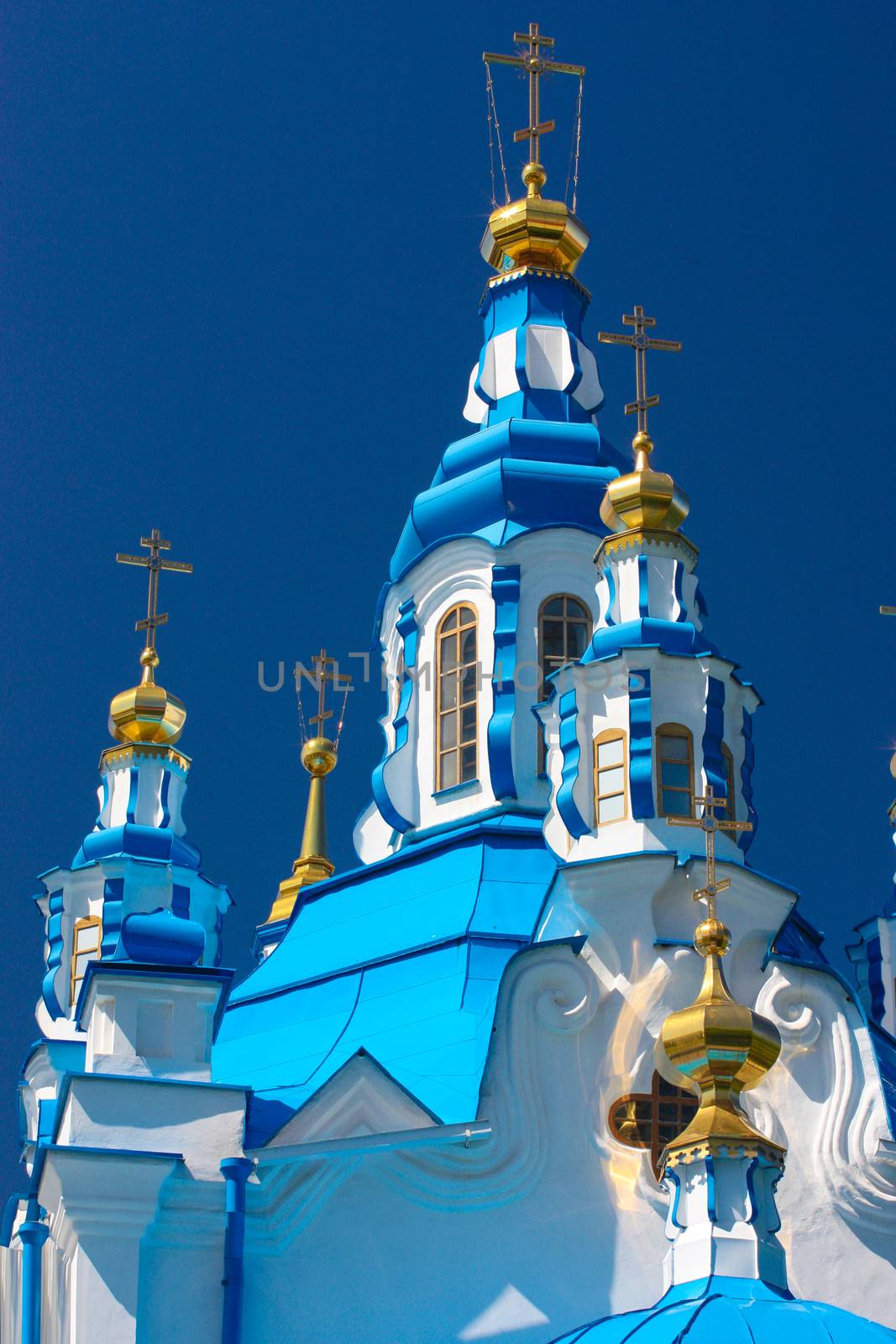 Beautiful blue and gold dome on a background of blue sky.