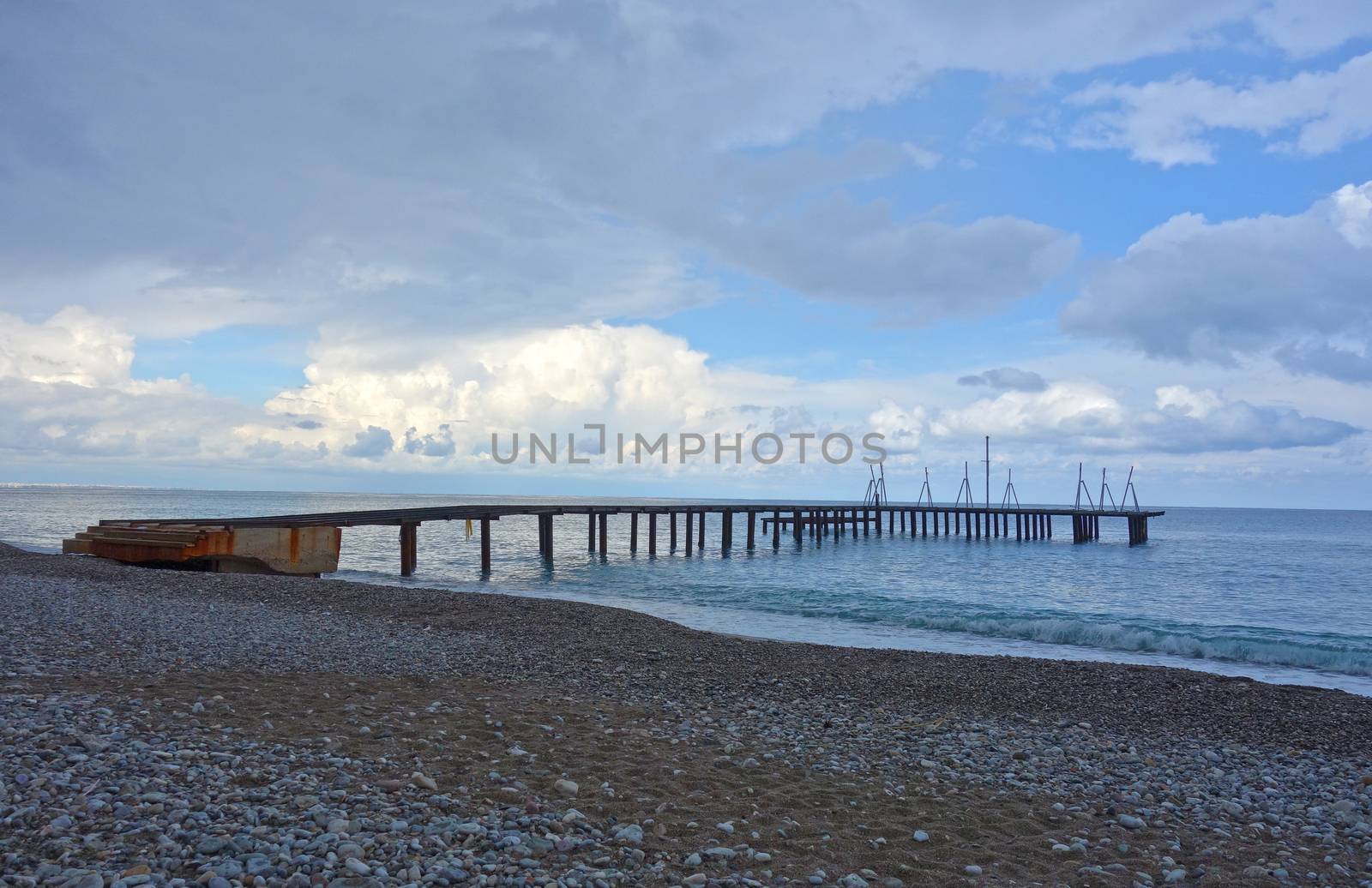 Pebble beach with pontoon bridge in Antalya