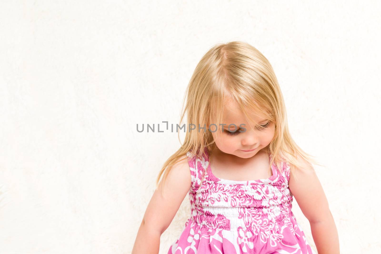 Portrait of Beautiful Toddler Girl Looking Down by scheriton