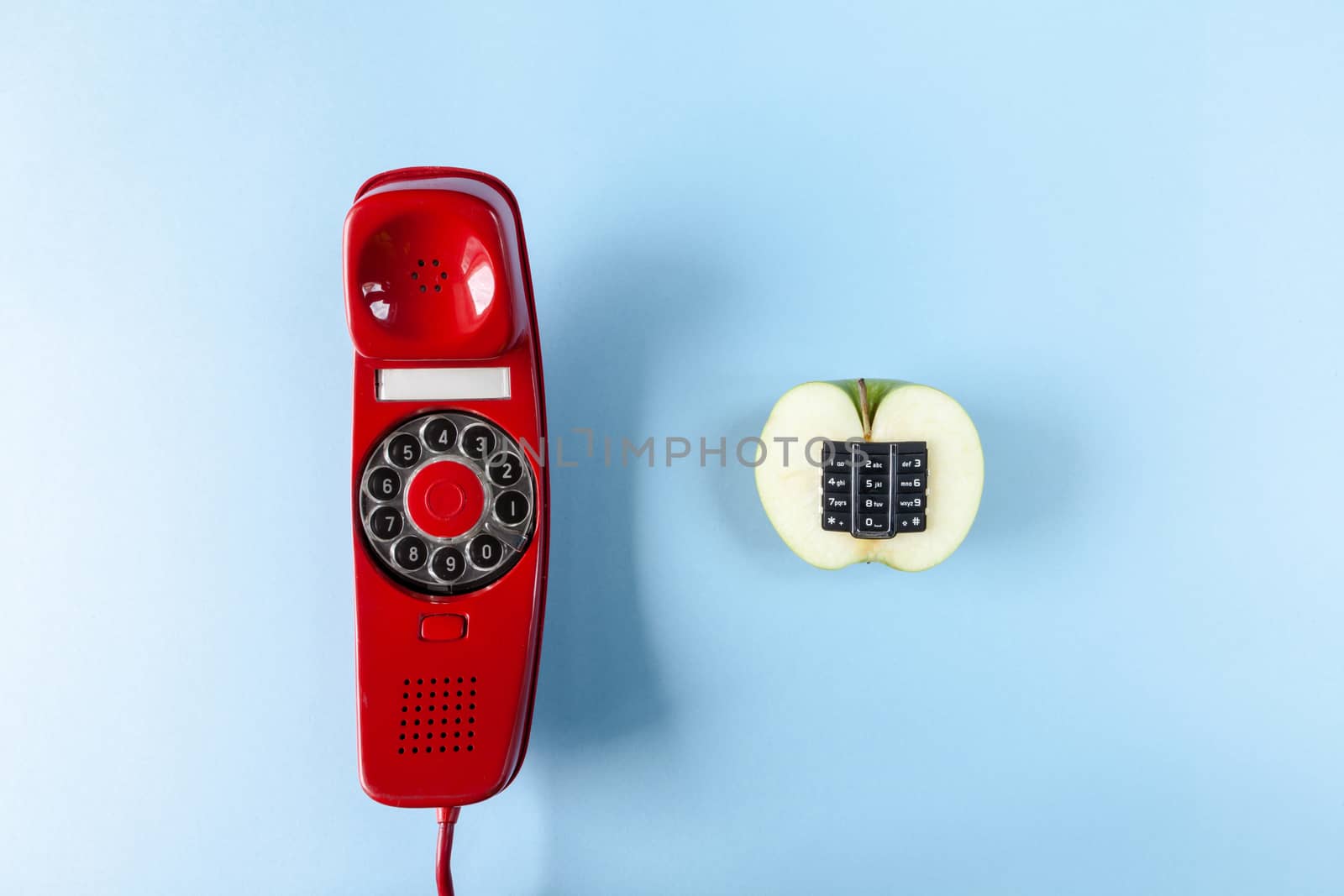 Alphanumeric apple and old red phone on a blue background