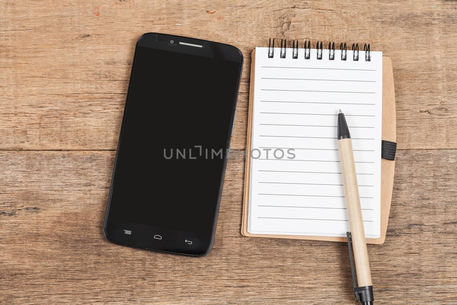 Note book  and smart phone on wood table