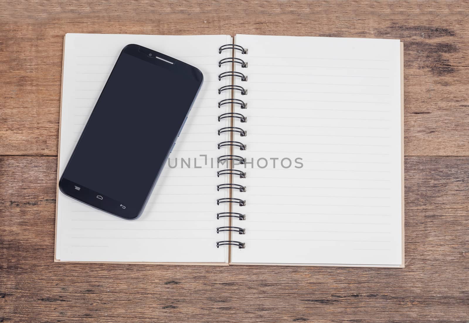 obile phone and book note in vintage wooden desk