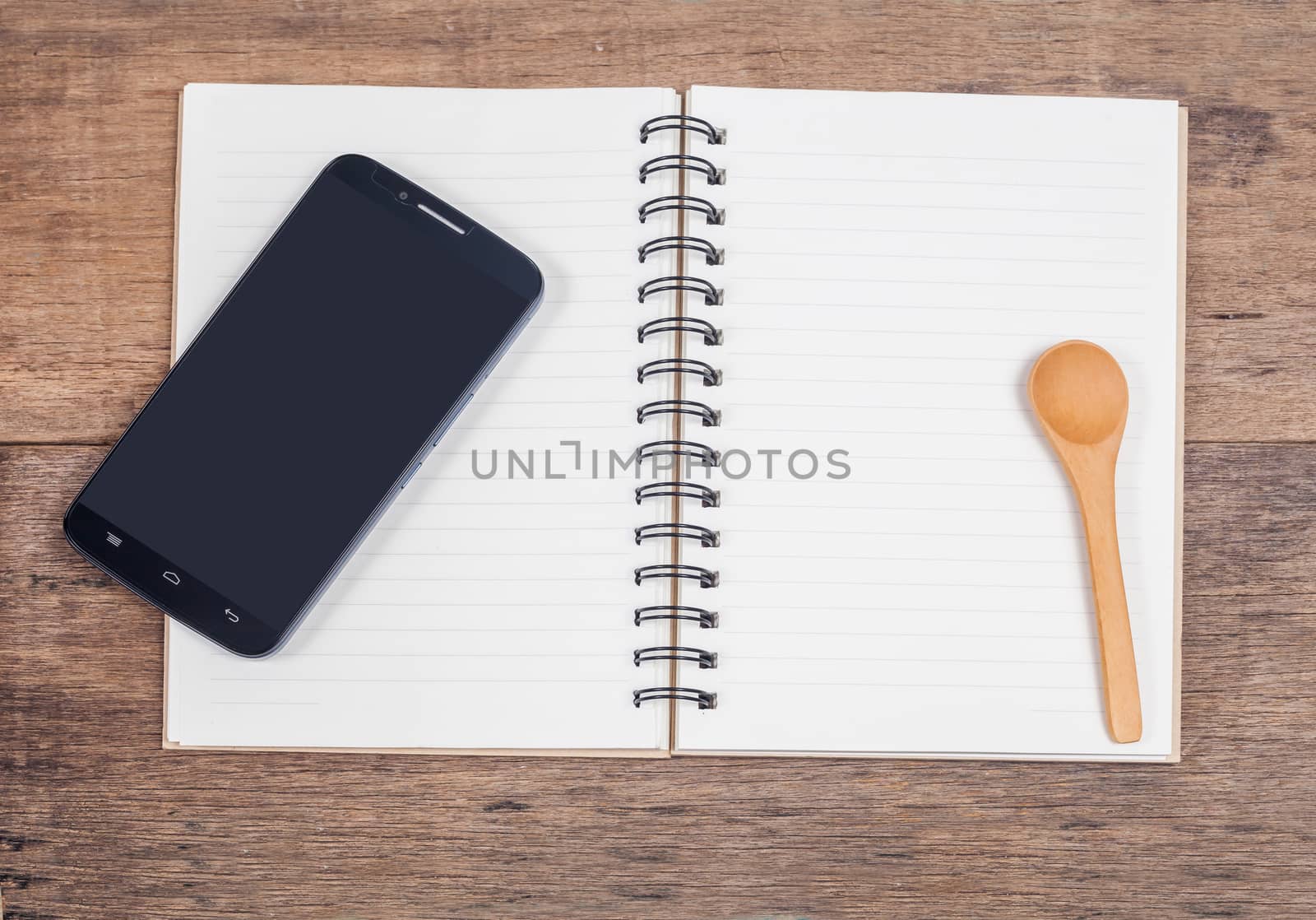 mobile phone and book note in vintage wooden desk