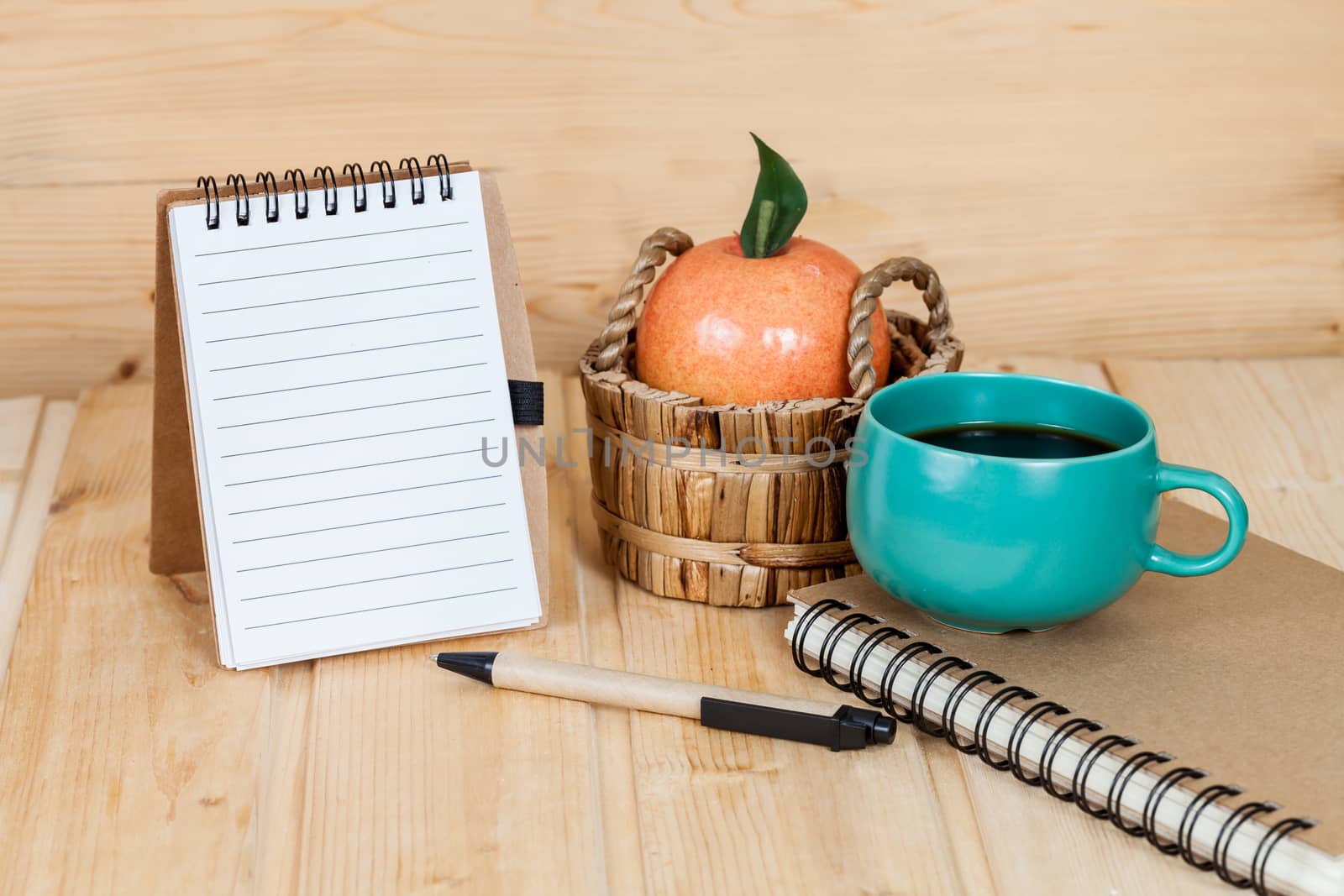 note book  and pen on wood table