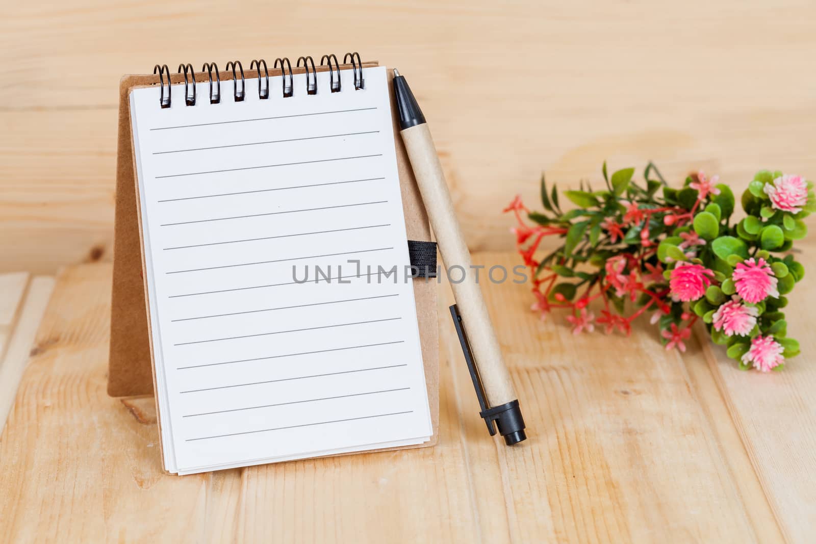 note book  and pen on wood table