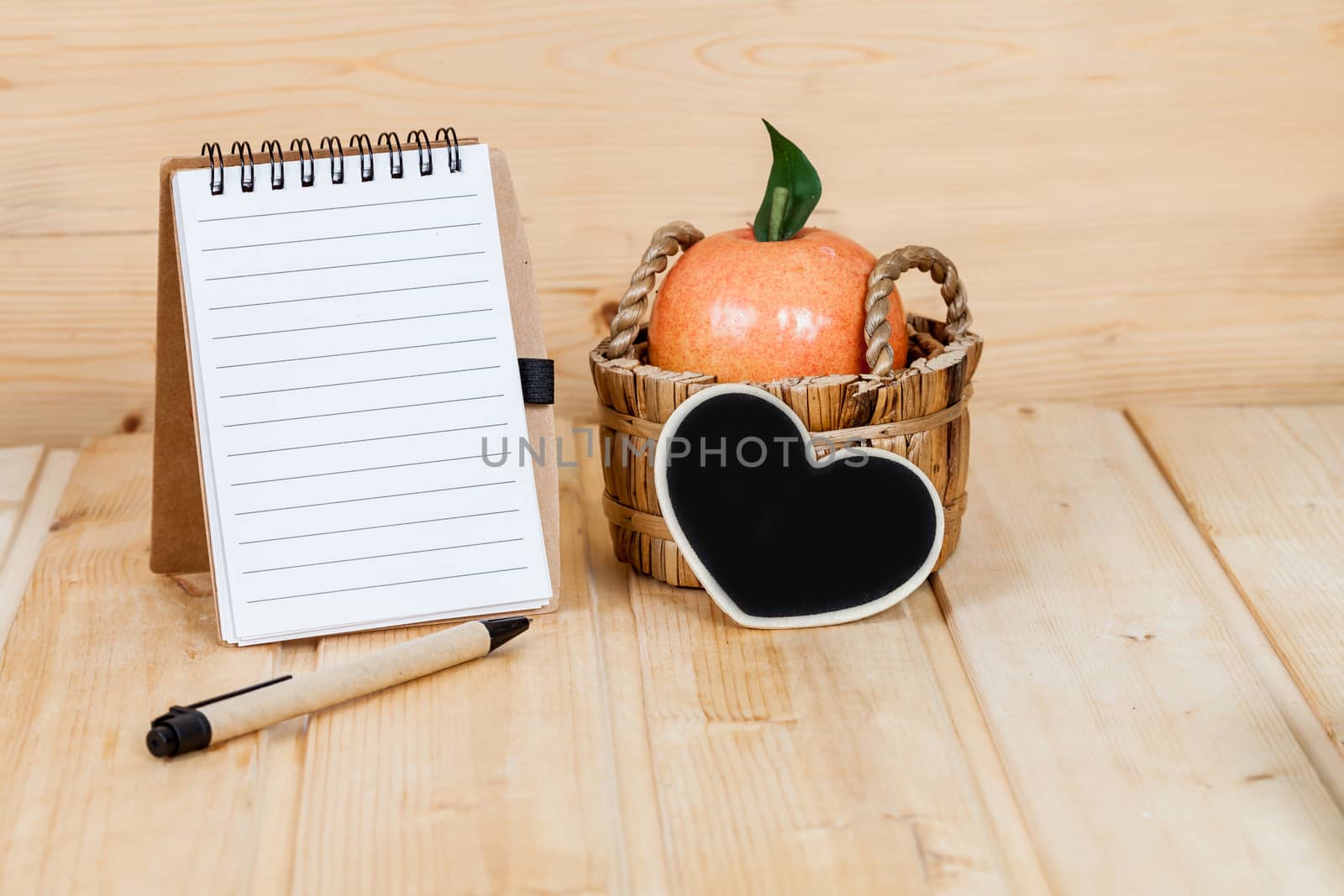 note book  and pen on wood table