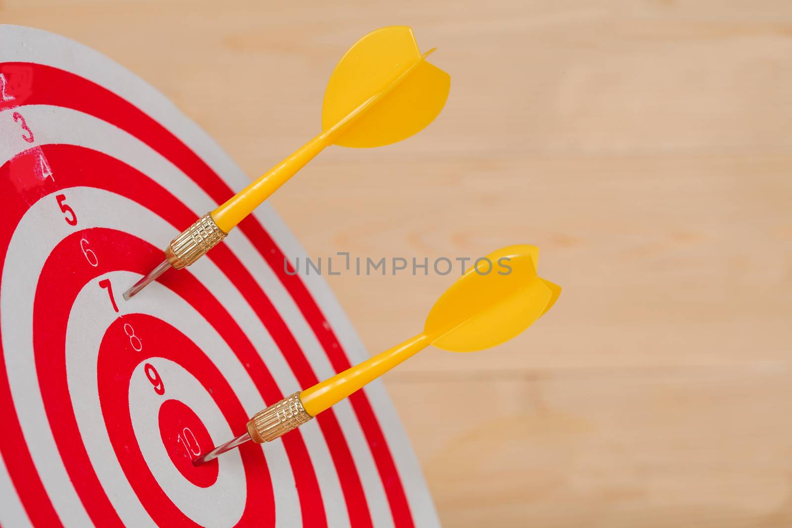 Dart arrow hitting in bullseye on dartboard