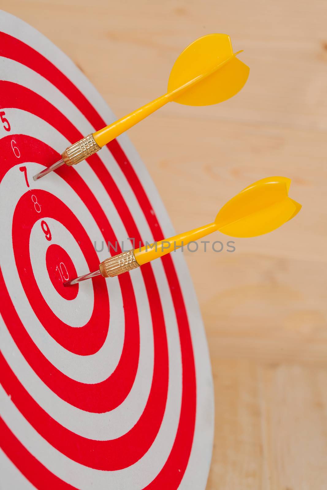 Dart arrow hitting in bullseye on dartboard