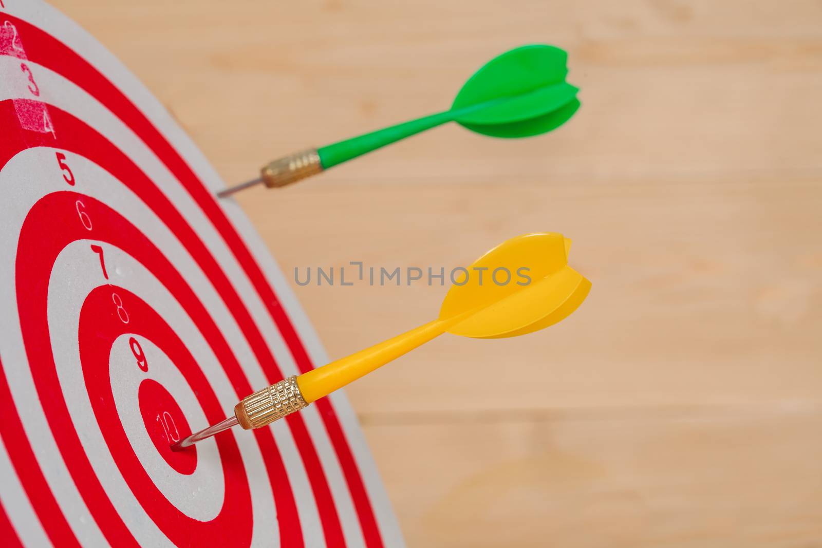 Dart arrow hitting in bullseye on dartboard