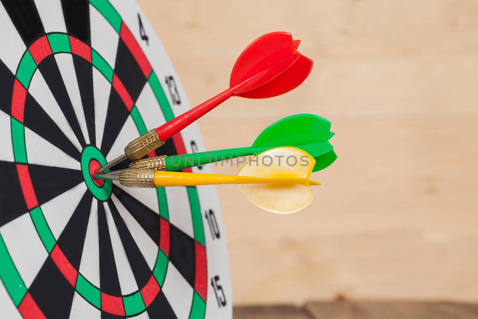 Dart arrow hitting in bullseye on dartboard