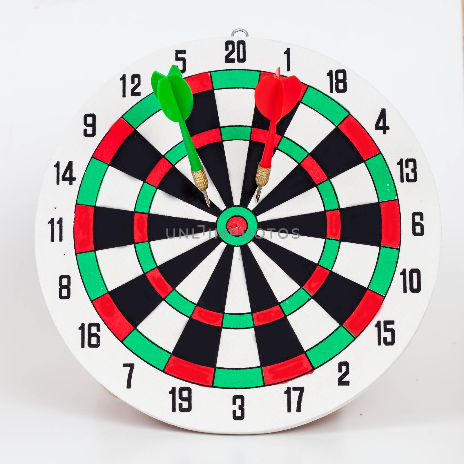 Dart arrow hitting in bullseye on dartboard