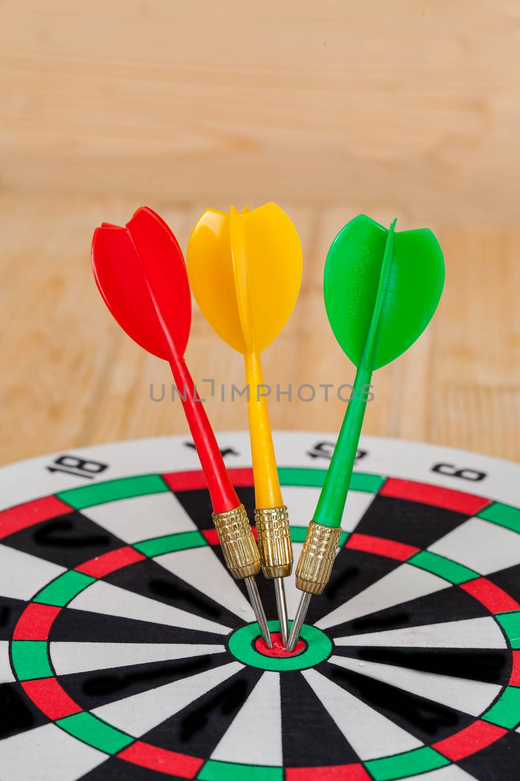 Dart arrow hitting in bullseye on dartboard
