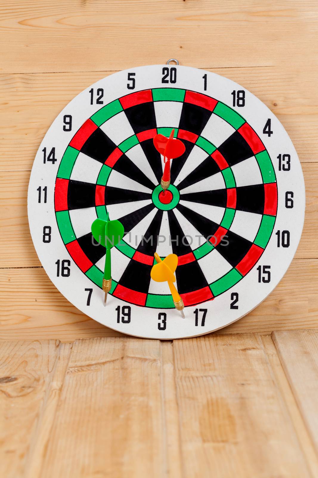 Dart arrow hitting in bullseye on dartboard