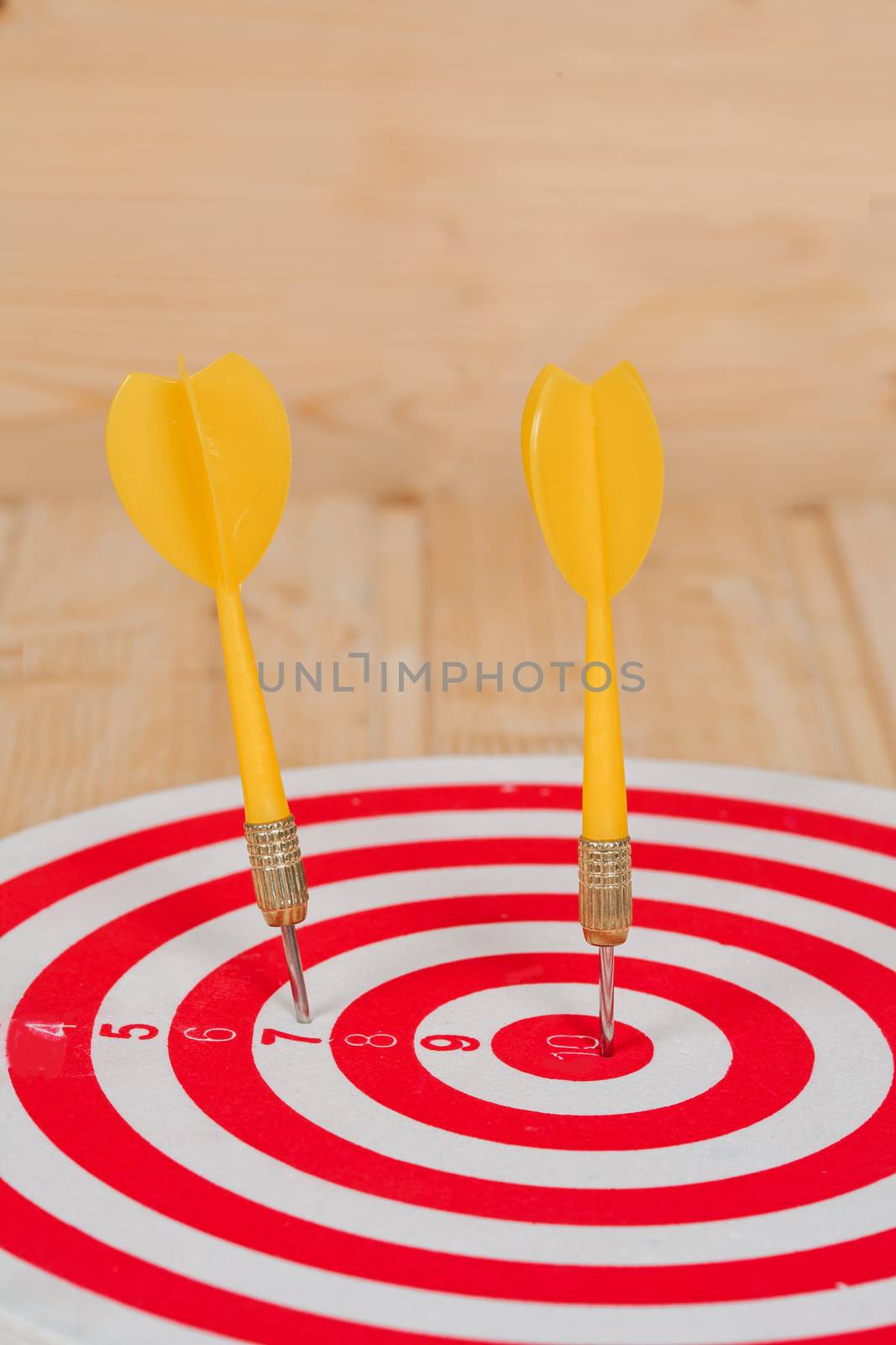 Dart arrow hitting in bullseye on dartboard