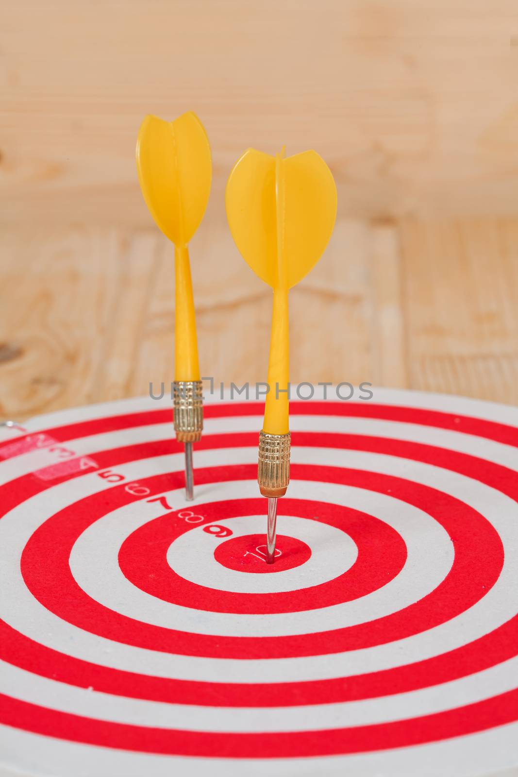 Dart arrow hitting in bullseye on dartboard