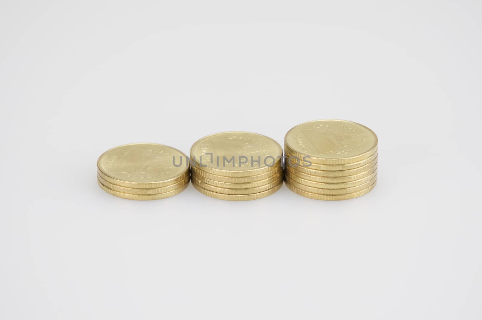 Close up step pile of gold coins isolated place on white background.