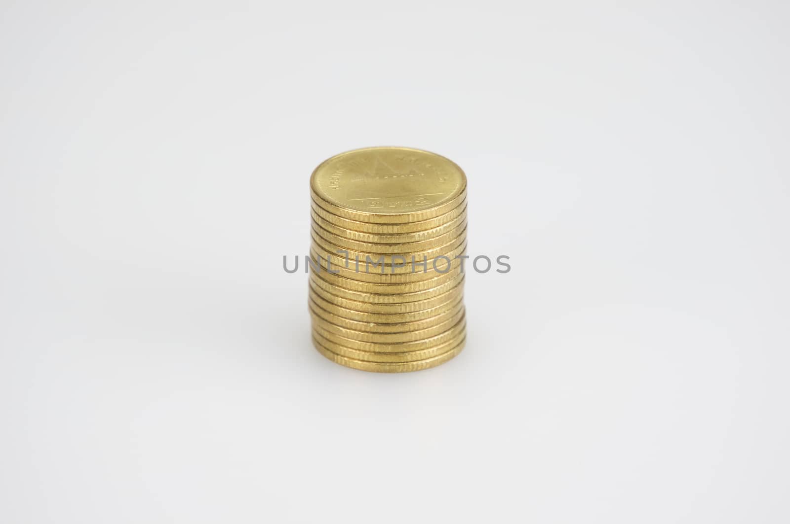 Close up pile of gold coins isolated on white background by eaglesky