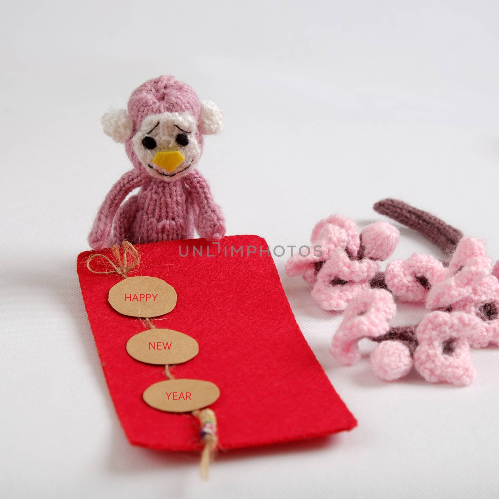 2016, year of monkey, handmade happy new year on white background, knitted monkey, funny stuffed animal, knit flower from yarn, red envelope for lucky money, sign for Vietnam Tet