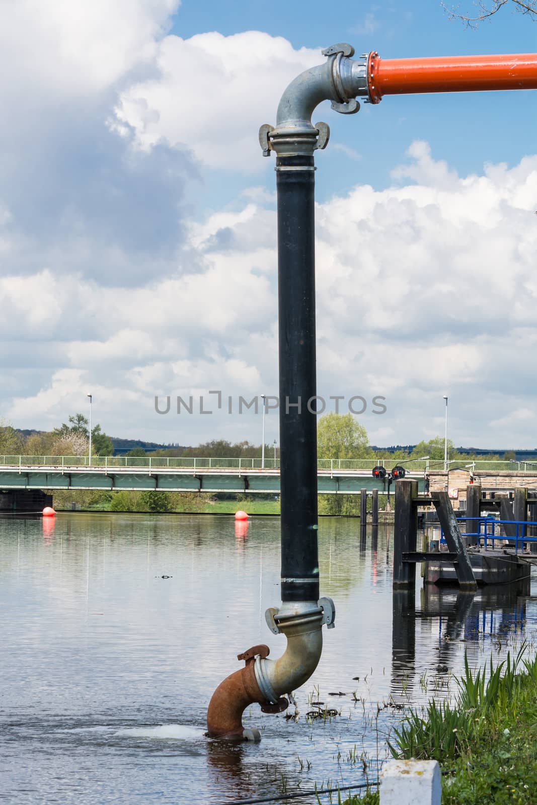 Pumping water from a river. by JFsPic