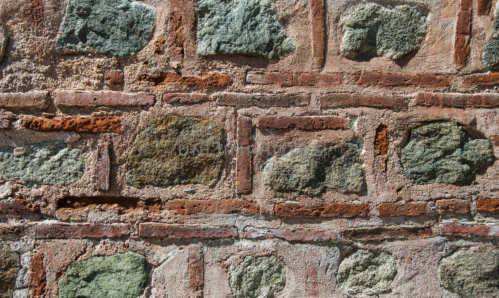 Red thin brick, concrete and stone rough pattern wall background.
