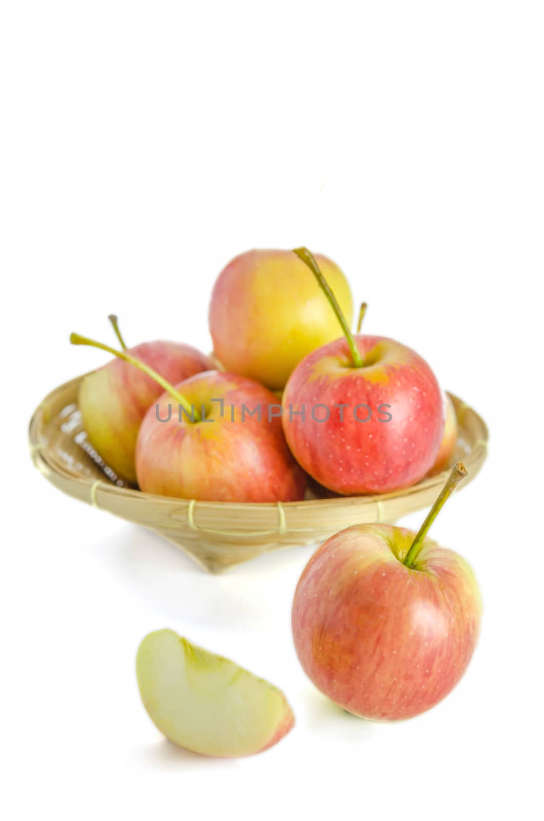 Red and yellow apple  with bamboo basket , organic fresh fruit.