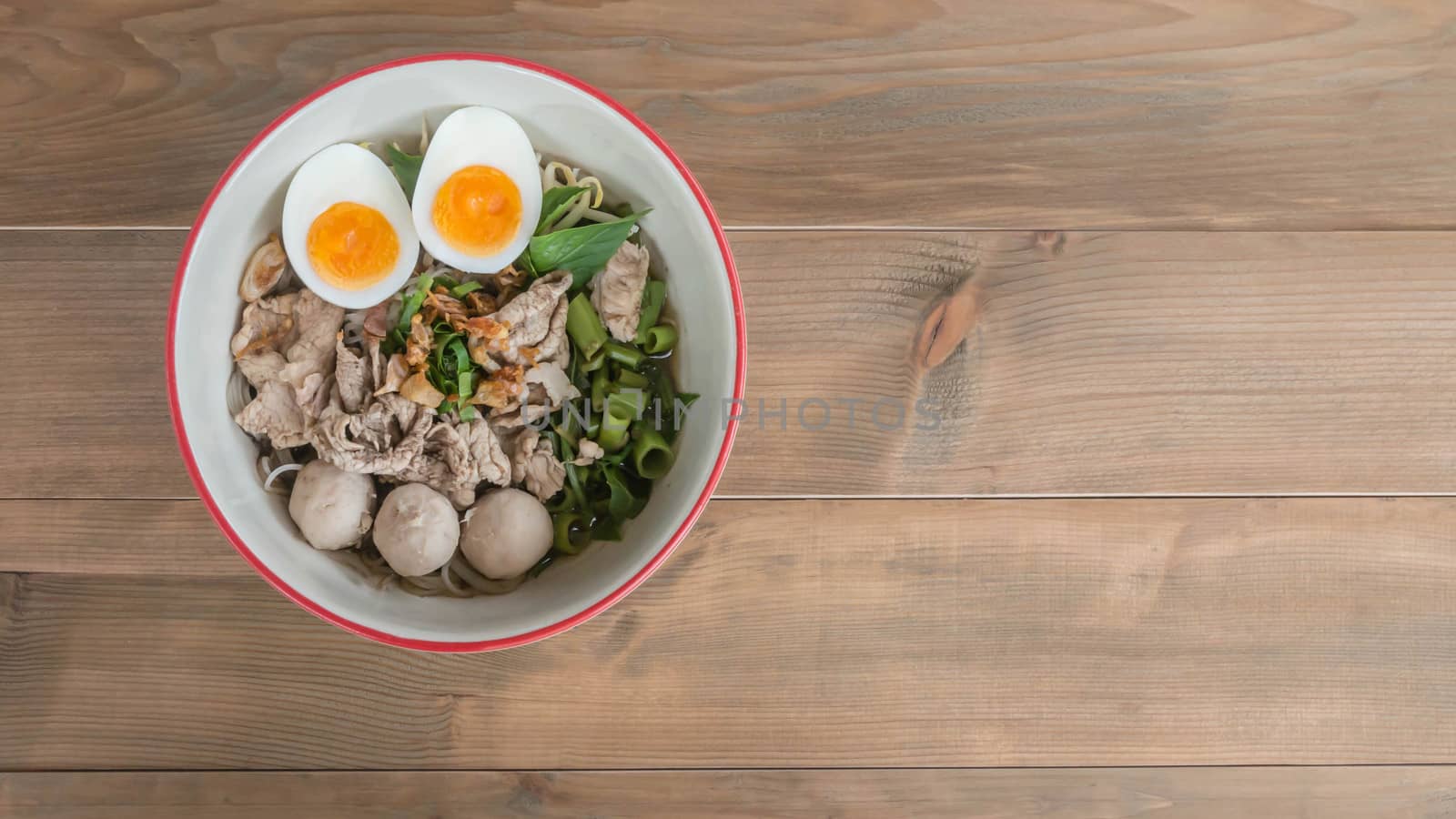 Asian white noodles with pork and vegetables in bowl over wooden background,  , Free space for text