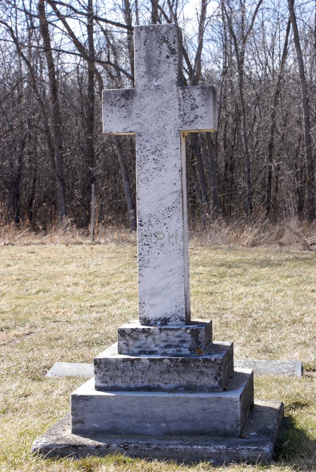 A lonely tombstone in an old cemetery.