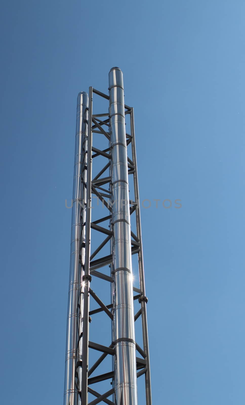 industrial steel chimney against a blue sky