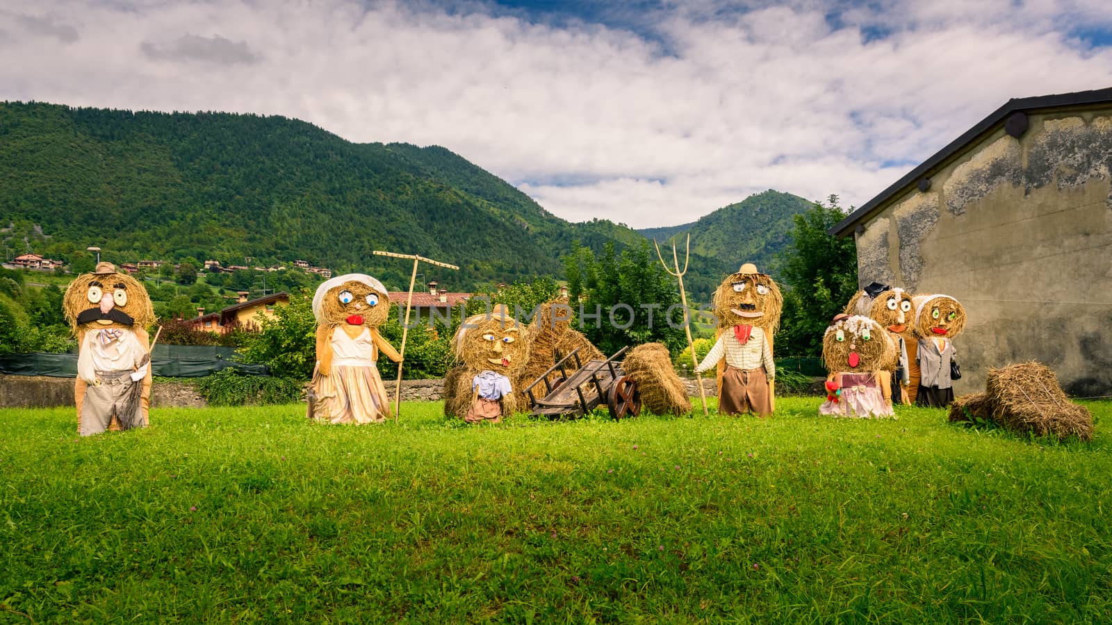 Typical big farmers family, Puppets(straw dolls) made out of Hay Bale with traditional peasant clothes in europe autumn.