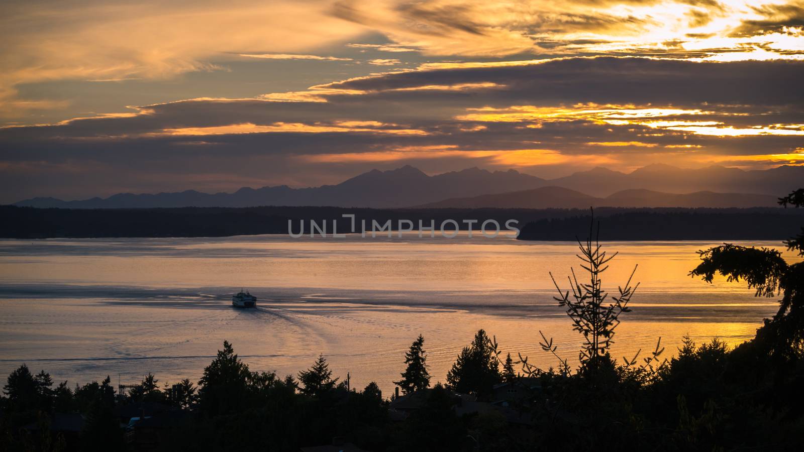 A ferry sails into the sunset in the Puget Sound