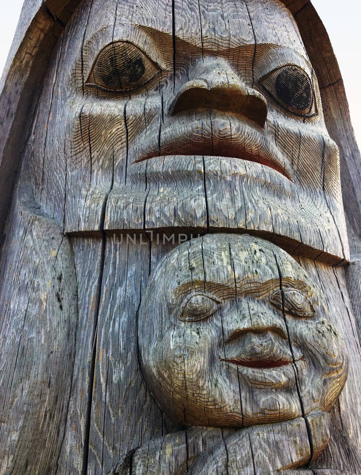 Vancouver, BC, Canada - 7/8/2012: Detail of a Songhees totem pole. A mother and her child are portrayed.
