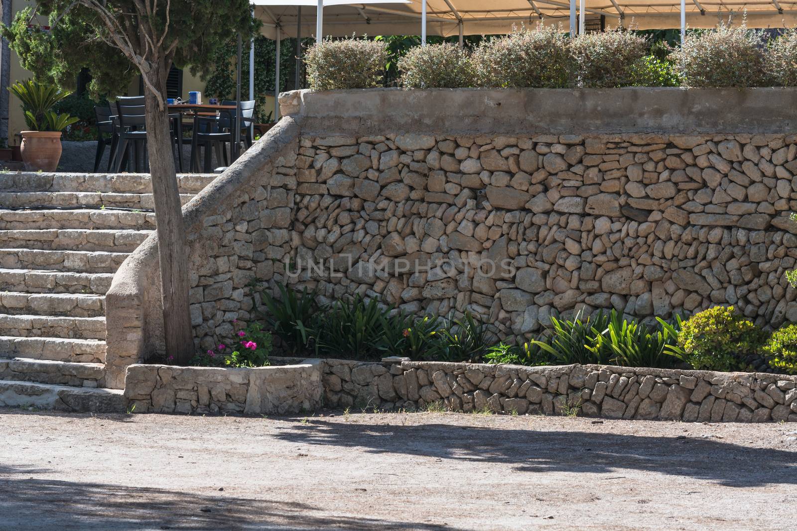 Mediterrane retaining wall made of natural stones for terrace.