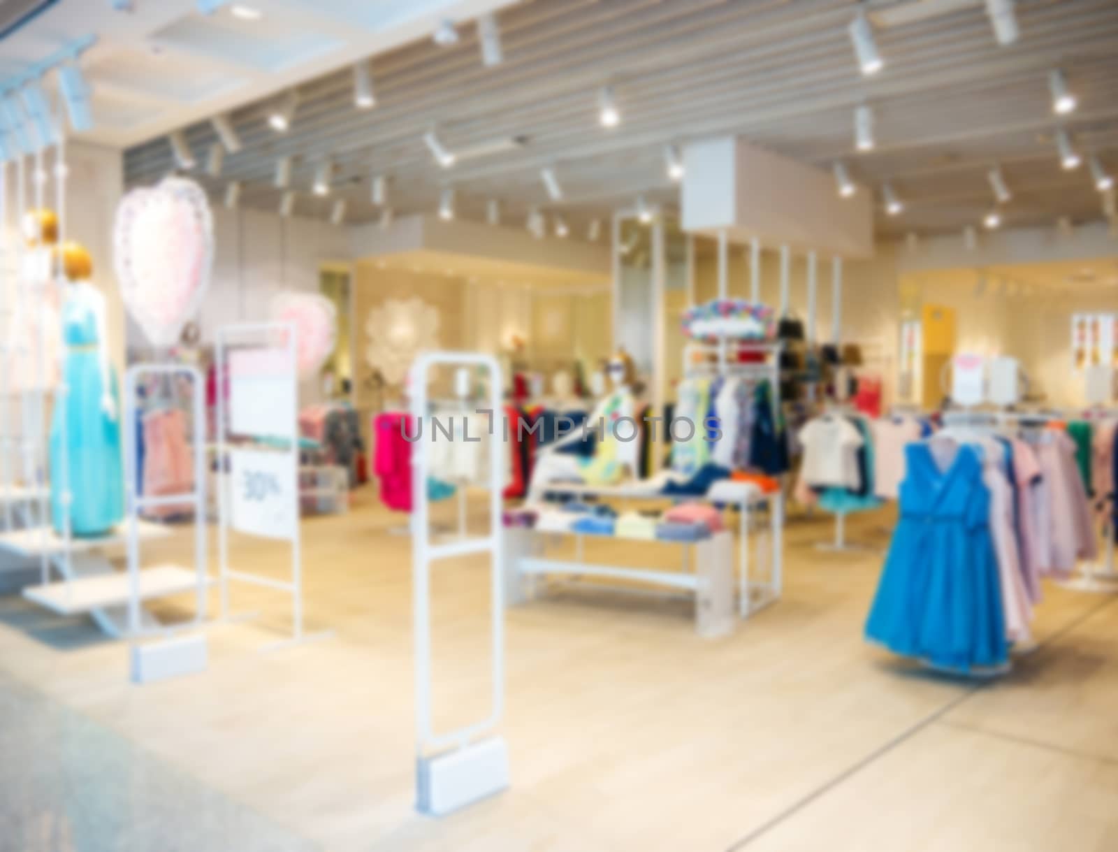 clothes in fashion store, blurred interior of cloth store