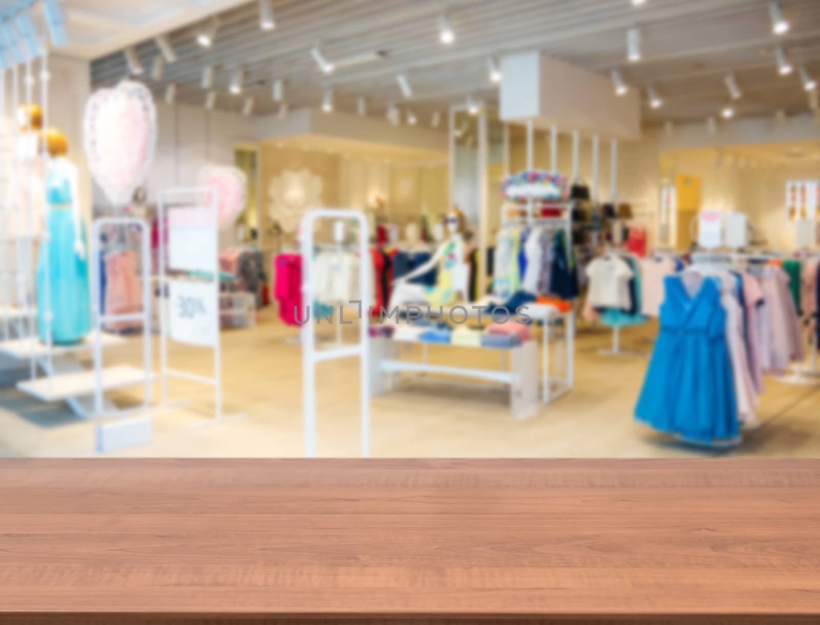 blurred interior of cloth fashion store by fascinadora
