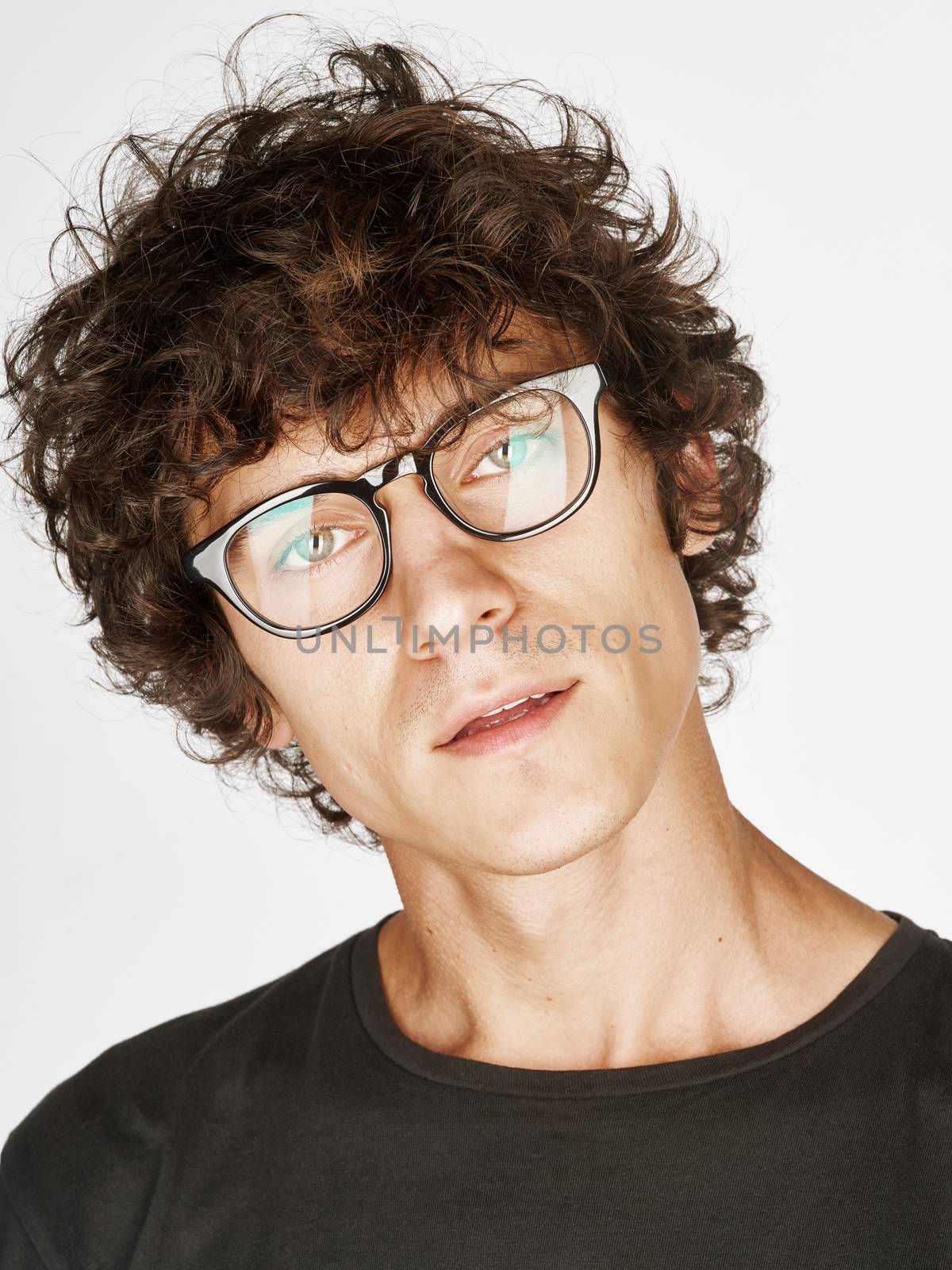 Emotional portrait of a pretty young man on white background