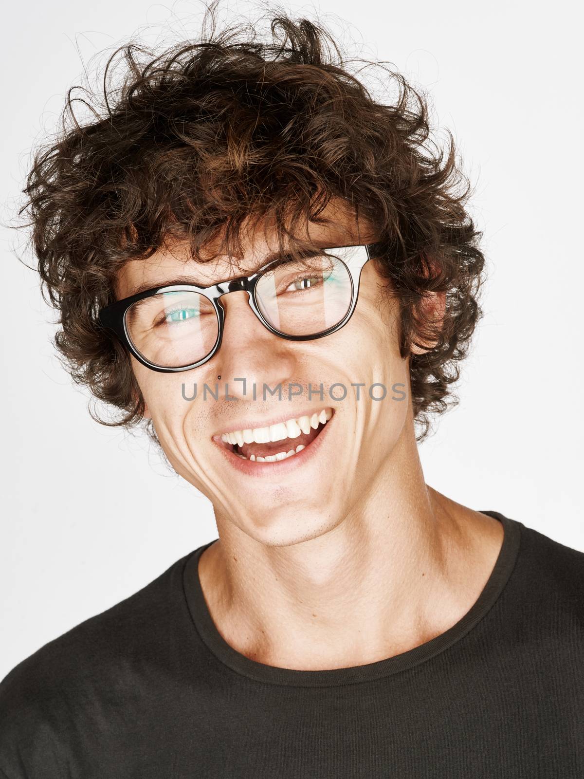 Emotional portrait of a pretty young man on white background