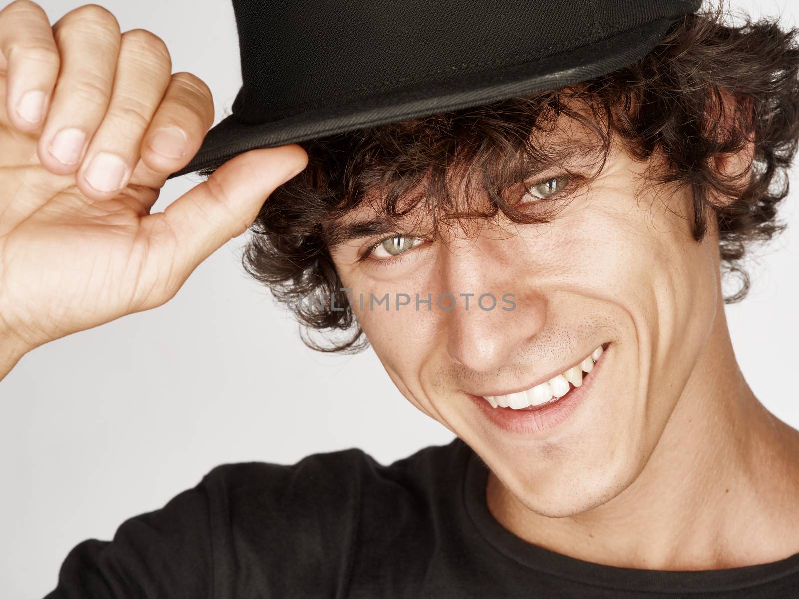 Emotional portrait of a pretty young man with cap