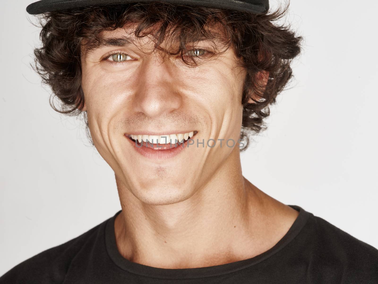 Emotional portrait of a pretty young man with cap