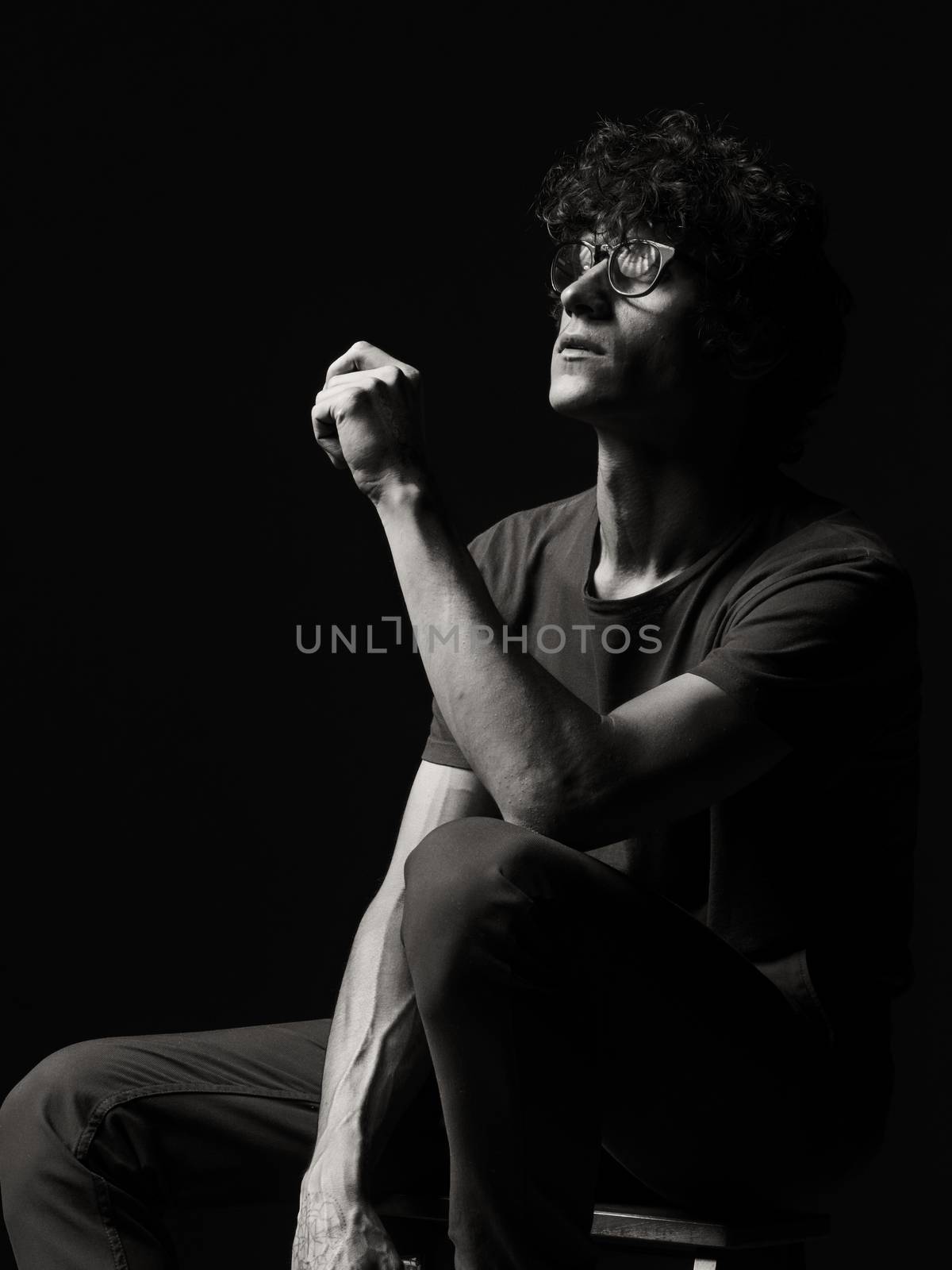 Emotional black and white dramatic portrait of a pretty young man