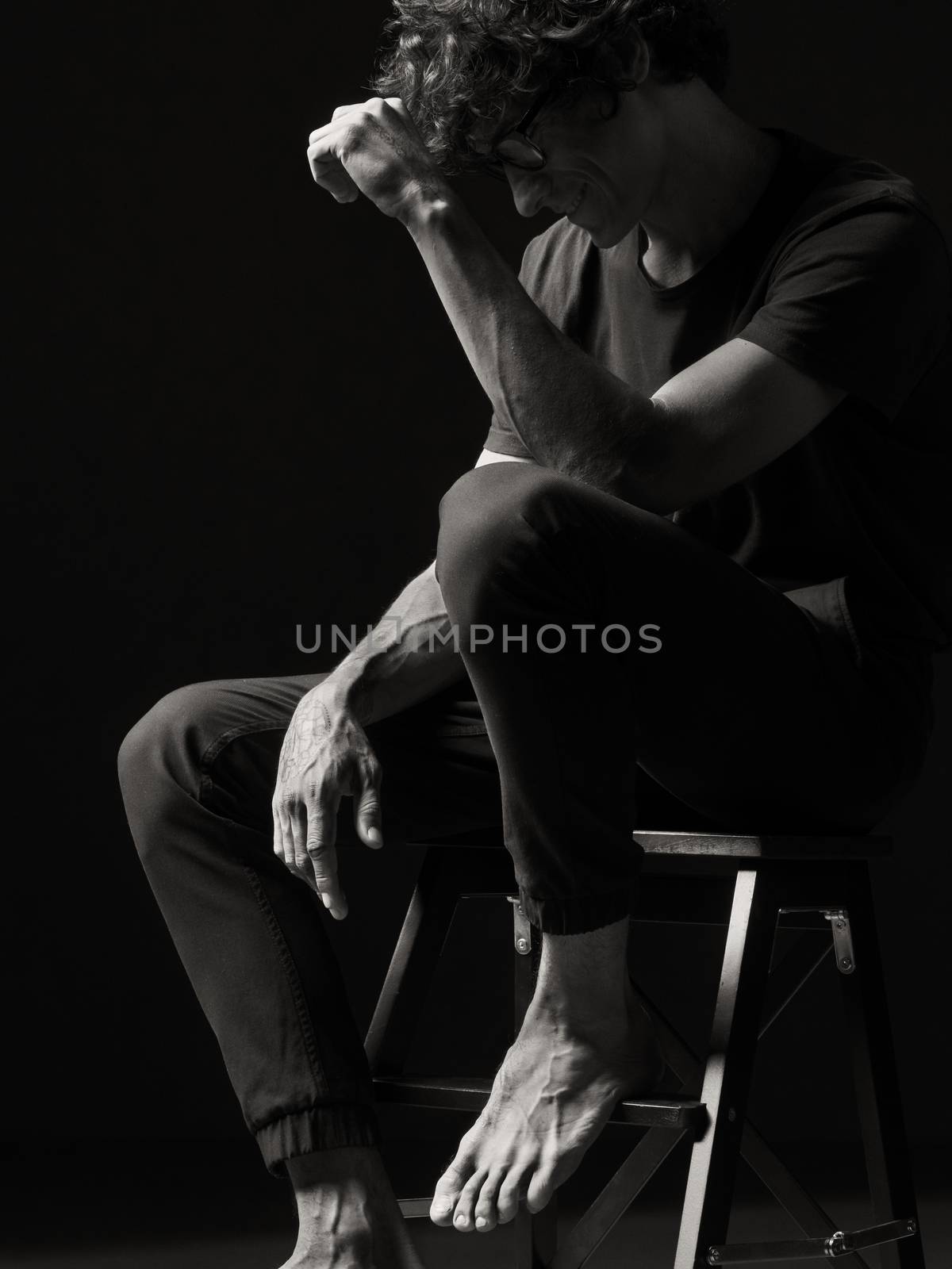 Emotional black and white dramatic portrait of a pretty young man