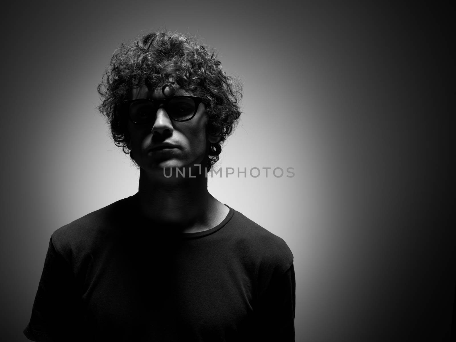 Emotional black and white dramatic portrait of a pretty young man